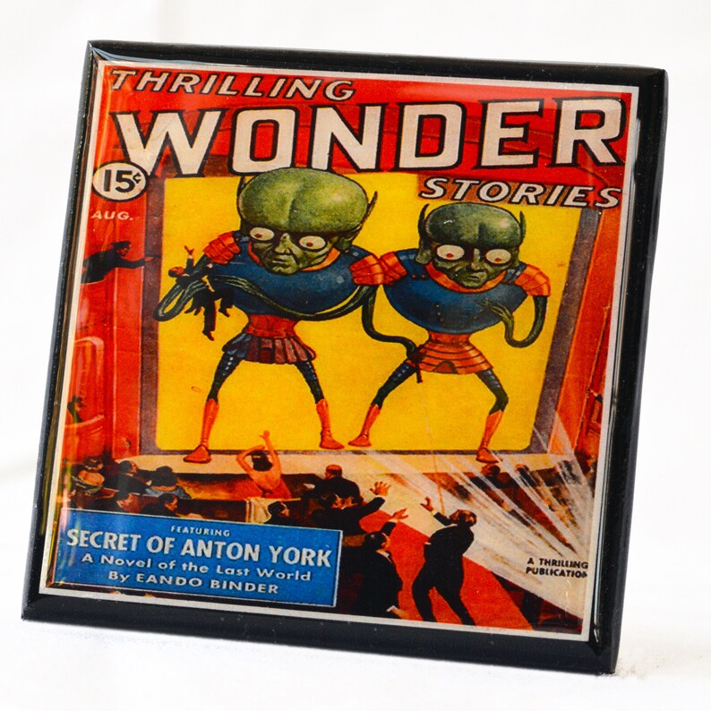 May include: A vintage comic book cover featuring a red, yellow, and blue illustration of two green alien creatures with large heads and wide eyes. The cover text reads "THRILLING WONDER STORIES" and "SECRET OF ANTON YORK A Novel of the Last World By EANDO BINDER".