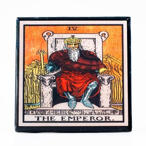 May include: Square tarot card featuring the Emperor. The image shows a seated figure in red robes, holding a scepter, with a crown. The background is orange with a mountain range. The card is framed in black with the title "THE EMPEROR."