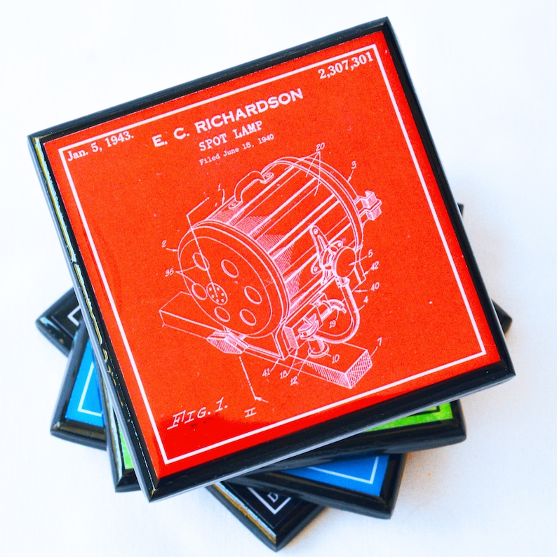 May include: A red square coaster with a black border features a vintage patent drawing of a spot lamp. The patent number 2,307,301 and the inventor's name E. C. Richardson are printed in white. The text "Jan. 5, 1943. Filed June 18, 1940" is also printed in white.