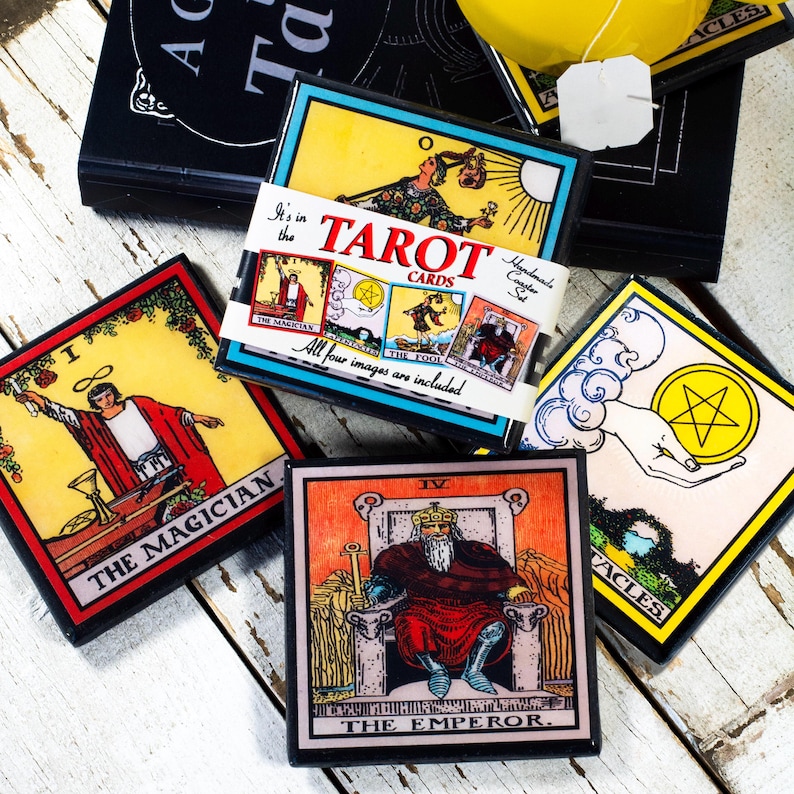 May include: A collection of tarot card coasters featuring vibrant illustrations and text. The coasters display images of The Magician, The Emperor, and other cards. The text "TAROT CARDS" is visible on a coaster, along with the phrase "All four images are included."