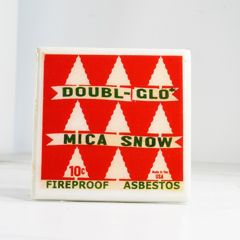 May include: A red and white box with a green and white label that reads "Double-Glo Mica Snow Fireproof Asbestos" and "10c Made in the USA".