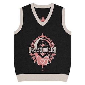 May include: Black V-neck sweater vest with a cream-colored trim. The vest features a pink and white floral design with the word "Overstimulated" in a decorative font. The design is centered on the chest.