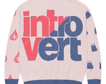 May include: A light pink sweater with the word "Introvert" in red and blue block letters. The sweater has blue trim on the collar and cuffs. Small red flame and blue ghost graphics are scattered across the sweater.