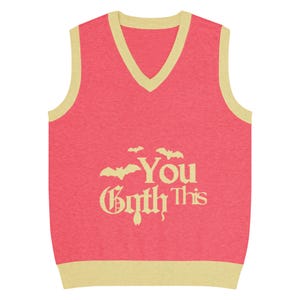 May include: A coral-colored V-neck sweater vest with a cream-colored trim. The vest features the phrase "You Goth This" in a gothic font, with bat silhouettes above the word "You".
