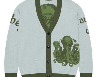 May include: Light blue cardigan sweater with a green octopus design and the text "be" on the left sleeve and "or, c" on the right sleeve. The sweater has a V-neck, button closure, and green trim.