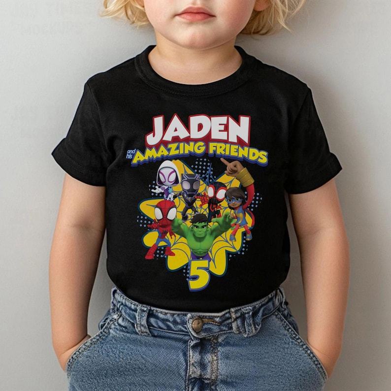 May include: Black t-shirt featuring the text "JADEN and his AMAZING FRIENDS" in white and yellow. The shirt has a graphic of several cartoon superheroes and the number 5 in yellow.