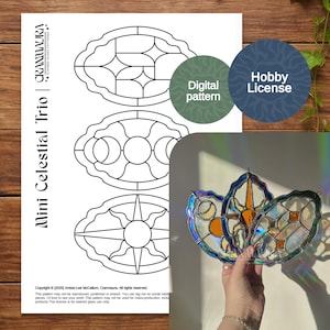 May include: A digital pattern for stained glass art, with three celestial designs: a sun, moon, and star. The image shows a finished stained glass piece and a "Hobby License" label. The text reads "Mini Celestial Trio" and "Digital pattern".
