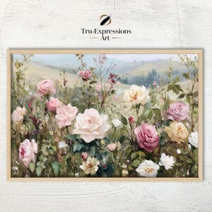 Op de afbeelding: Een ingelijste kunstprint met een veld vol rozen in verschillende tinten roze, wit en geel. Het schilderij heeft een zachte, impressionistische stijl met een landschapsachtergrond. Het kunstwerk is gesigneerd "Tru-Expressions Art".