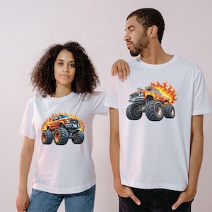 May include: White t-shirts featuring a vibrant graphic of a monster truck engulfed in flames. The monster truck is orange and red with large black tires. The shirts are worn by a man and a woman.