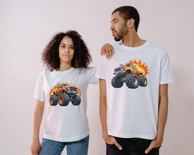 May include: White t-shirts featuring a vibrant graphic of a monster truck engulfed in flames. The monster truck is orange and red with large black tires. The shirts are worn by a man and a woman.