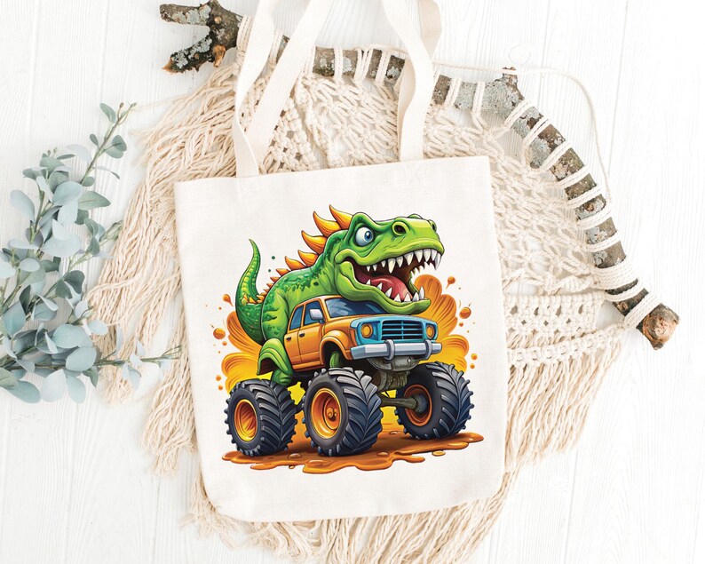 May include: White canvas tote bag featuring a cartoon dinosaur driving a monster truck. The dinosaur is green with orange spikes, and the truck is orange and blue. The design is set against a yellow and orange background.
