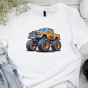 May include: White t-shirt featuring a cartoon monster truck design. The truck is orange with black tires and flames on the side. The shirt is made of a soft, comfortable material.