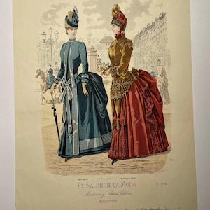 May include: An antique fashion illustration titled "EL SALON DE LA MODA" featuring two women in elaborate Victorian-era dresses. The illustration is in color, with the women standing on a street with a horse-drawn carriage in the background. The text "BARCELONA" is visible.