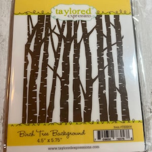 May include: A clear plastic package containing a die-cut birch tree background. The trees are brown, with a white background. The package is labeled "Birch Tree Background" and measures 4.5" x 5.75".