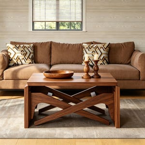 May include: A brown sofa with two decorative pillows and a wooden coffee table. The coffee table has a crisscross base and a wooden bowl on top. Two wooden candle holders with lit candles are also on the table.
