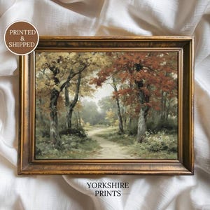 May include: A rectangular landscape painting in a dark gold frame depicting a forest path with trees featuring autumn foliage in shades of red, orange, and green. A circular badge in the top left corner reads PRINTED & SHIPPED, and text at the bottom reads YORKSHIRE PRINTS.