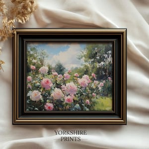 Puede incluir: Pintura enmarcada que representa un jard&iacute;n de rosas rosas bajo un cielo azul con nubes blancas. La obra de arte est&aacute; en un marco negro y dorado. El texto "YORKSHIRE PRINTS" est&aacute; en la parte inferior del marco.