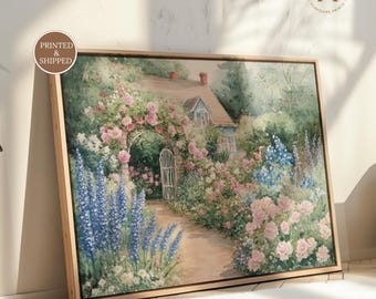 May include: A framed landscape painting featuring a cottage with a stone archway covered in pink roses, a dirt path, and tall blue delphinium flowers. The artwork includes a circular logo in the top right corner with the text YP Yorkshire Prints.