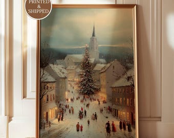 May include: A framed wall art print featuring a snowy winter village scene at dusk. A large, illuminated Christmas tree stands in the center of a street lined with buildings, with people walking below. The text YORKSHIRE PRINTS and PRINTED & SHIPPED appear.