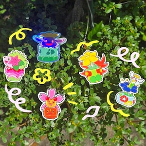 May include: A collection of five colorful stickers featuring stylized creatures emerging from potted plants, including a purple creature in a green pot, a pink floral figure, a yellow flower-like being, and a winged character in a blue flower.