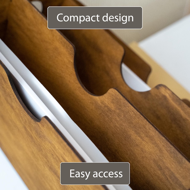 K&ouml;nnte beinhalten: Nahaufnahme eines Holzorganizers mit mehreren Schlitzen. Der Organizer besteht aus gebeiztem Holz und hat ein kompaktes Design. Der Text "Compact design" und "Easy access" sind auf dem Bild zu sehen.