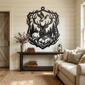 May include: A black metal wall art piece featuring a detailed silhouette design of a deer with large antlers, a flying duck above, and a fish jumping in water, all framed within a decorative border of pine trees and intricate scrollwork.