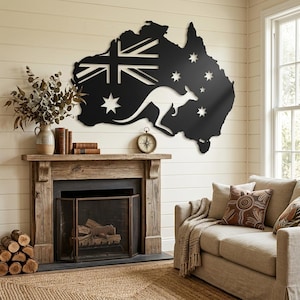 May include: A black metal wall art piece shaped like the map of Australia, featuring a cutout design of the Australian flag's Union Jack, the Commonwealth Star, and the Southern Cross constellation, along with a silhouette of a kangaroo.