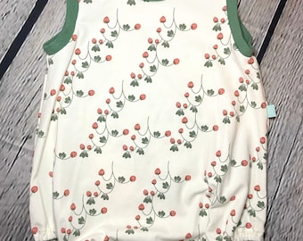 May include: A white sleeveless baby onesie with a green trim and a red strawberry pattern. The onesie has a snap closure at the bottom.