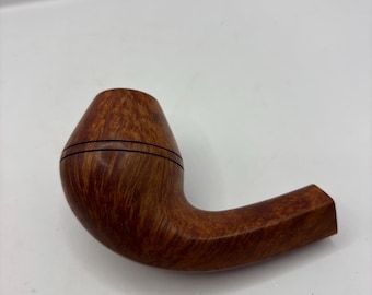 May include: A curved, wooden tobacco pipe with a rounded bowl and a bent stem. The pipe is a warm brown color with darker grain patterns and two thin, black bands around the bowl. The stem has a square end.