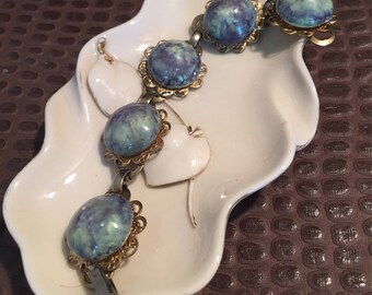 Retro  blue, gray ceramic stones on a silver and gold tone bracelet .