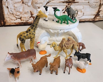 lot of old vintage animals, toy animals, plastic animals, giraffe, cow, dinosaur, camel, chicken toy