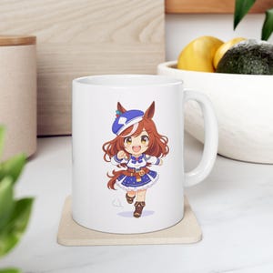 May include: White ceramic mug featuring a colorful anime-style illustration of a character with brown hair, a blue hat, and a blue and white outfit. The character is running. The mug has a white handle and is on a beige coaster.
