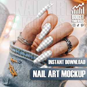 May include: A hand with long, transparent nail art mockups, adorned with silver rings. The image includes the text "INSTANT DOWNLOAD" and "NAIL ART MOCKUP" on a blue banner, with a graphic that says "BOOST YOUR REACH".