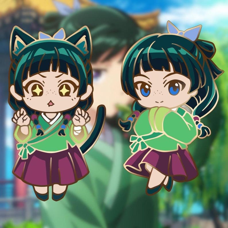May include: Two enamel pins featuring a cartoon character in traditional Korean clothing. One pin has cat ears and a tail, the other has a blue bow. Both have green tops, purple skirts, and gold accents.