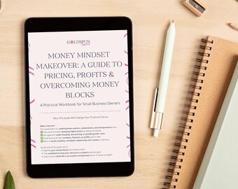 May include: A digital tablet shows a workbook titled "Money Mindset Makeover: A Guide to Pricing, Profits & Overcoming Money Blocks." A pen, notebooks, a pencil sharpener, and a pencil are arranged on a light wooden surface.