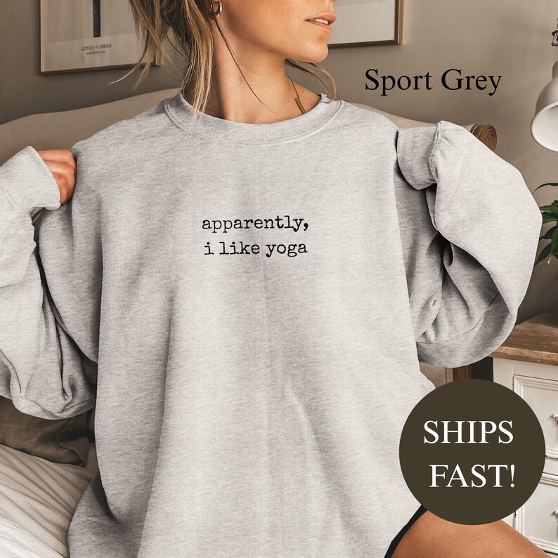 Grey sweatshirt with "apparently, i like yoga" text.