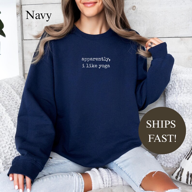 Navy sweatshirt with "apparently, I like yoga" text.