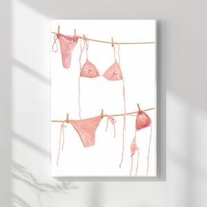 May include: A watercolour painting showing several pink bikinis hanging on a washing line with wooden pegs. The bikinis are in different styles, including a triangle top and a string bikini bottom. The background is white.