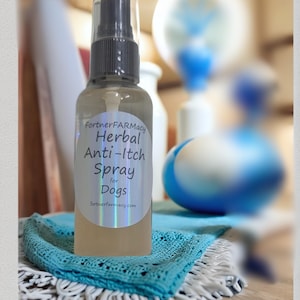 May include: A clear spray bottle with a black and clear spray nozzle. The label reads "FortnerFArmacy Herbal Anti-Itch Spray for Dogs". The bottle sits on a turquoise crocheted cloth. The background is blurred.