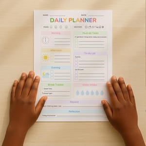 May include: A colorful daily planner with sections for mood, weather, and tasks. The planner includes areas for morning, afternoon, and evening schedules, a break tracker, water intake, and a reward section. The planner is held by two hands.