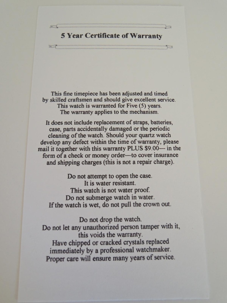May include: A white rectangular paper document titled 5 Year Certificate of Warranty. The text outlines terms for a quartz watch mechanism, including coverage details, water resistance warnings, and instructions for professional maintenance and care.