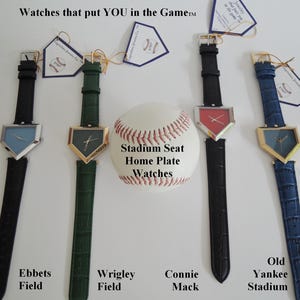May include: Four wristwatches with home plate-shaped faces and textured leather straps in black, green, black, and blue. A baseball sits in the center with the text Stadium Seat Home Plate Watches. Each watch has a tag labeled Ebbets Field, Wrigley Field, Connie Mack, or Old Yankee Stadium.
