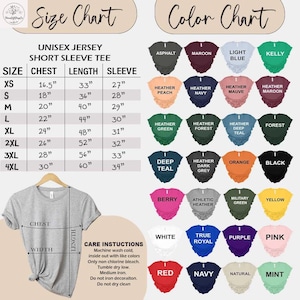 May include: A gray unisex short sleeve tee shirt hangs on a wooden hanger. The image includes a size chart with measurements in inches and a color chart with various shirt colors. Care instructions are also listed.
