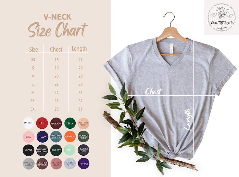 May include: A light gray V-neck t-shirt hanging on a wooden hanger, with a size chart and color options displayed. The size chart shows chest and length measurements in inches. The shirt is styled with a knot at the bottom.