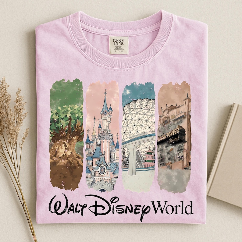 May include: A light pink t-shirt featuring four vertical rectangular panels with illustrations of Walt Disney World landmarks. The shirt has the words "Walt Disney World" in a cursive font at the bottom.