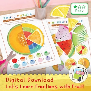 May include: Educational fruit-themed puzzle game with the text "Fruit Puzzle" and "Let's Learn Fractions with Fruit!" The game features colorful fruit illustrations, fraction pie charts, and the word "Easy". Includes a pair of pink scissors.