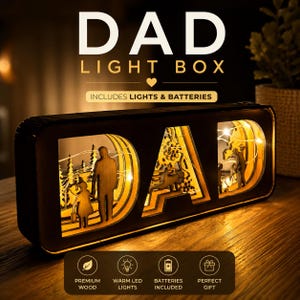 May include: A rectangular wooden light box featuring the word DAD cut out in large letters. Each letter contains a layered silhouette scene of a person with a child, illuminated by warm LED string lights. The text DAD LIGHT BOX is visible above.