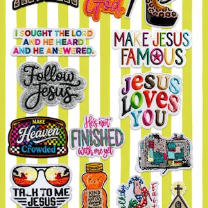 May include: A collection of colorful embroidered patches with religious themes. The patches feature phrases like "Amen," "But God," "Jesus Loves You," and "Prayer Warrior." Other patches include a high heel, sunglasses, and a church.