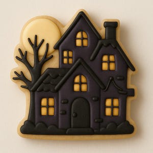 May include: A Halloween-themed cookie shaped like a haunted house. The house is dark purple with black trim, a chimney, and glowing yellow windows. A full moon and a bare tree are in the background, all on a light-colored cookie base.