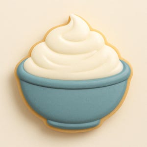 May include: A biscuit decorated to resemble a bowl of whipped cream. The biscuit has a pale brown outline, a blue bowl, and a swirl of white icing. The background is a plain, light beige colour.
